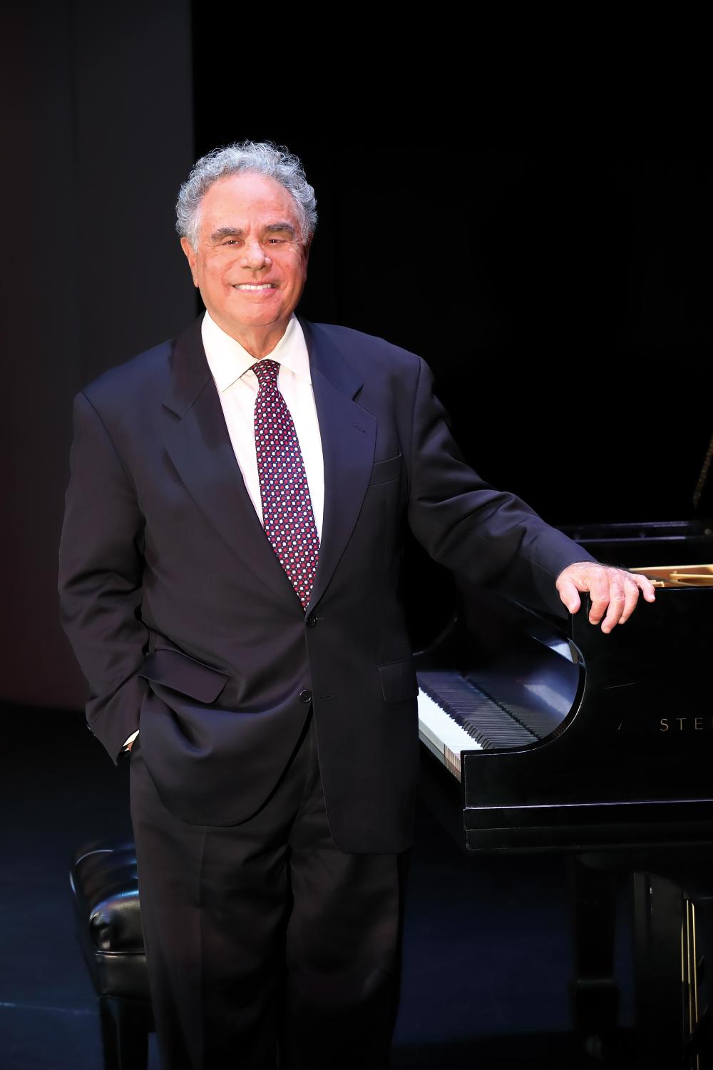 Jeffrey Siegel standing next to piano